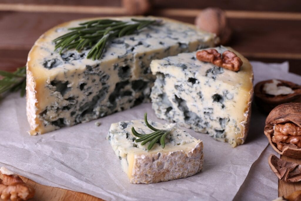 Blue cheese on wooden board.