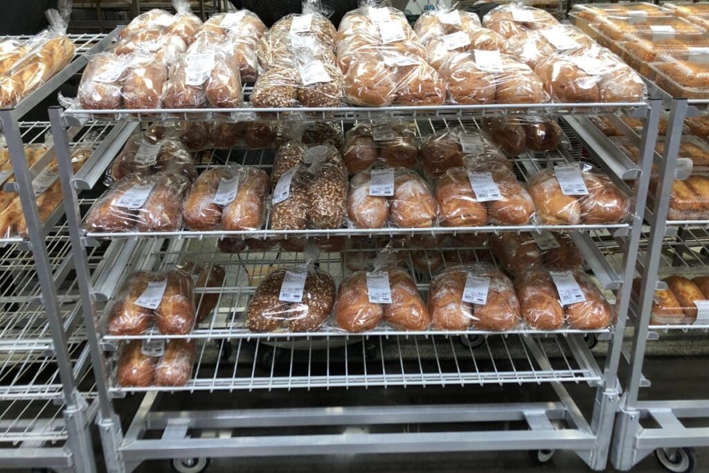 Bread displayed on racks inside a store.