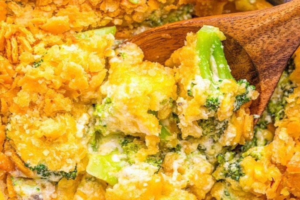 Close up of broccoli casserole on a wooden spoon.