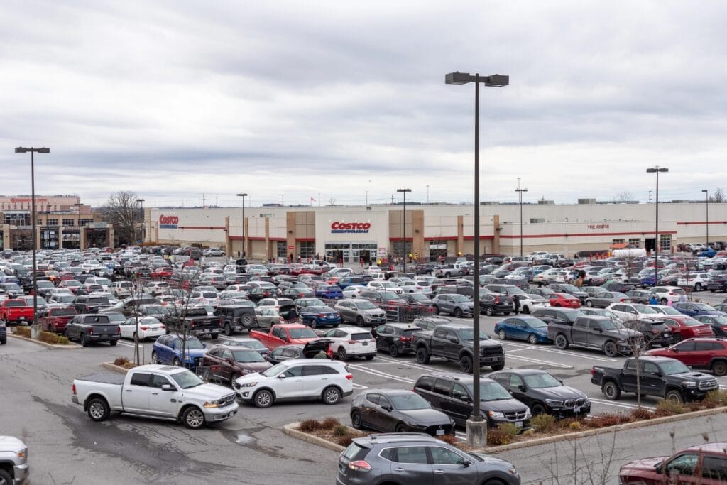 Chaotic parking lot with cars parked disorderly.