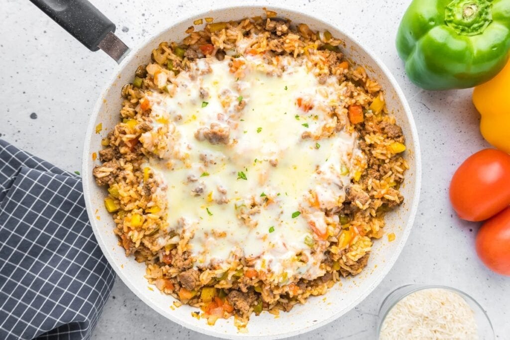 Cheesy unstuffed pepper in a skillet.