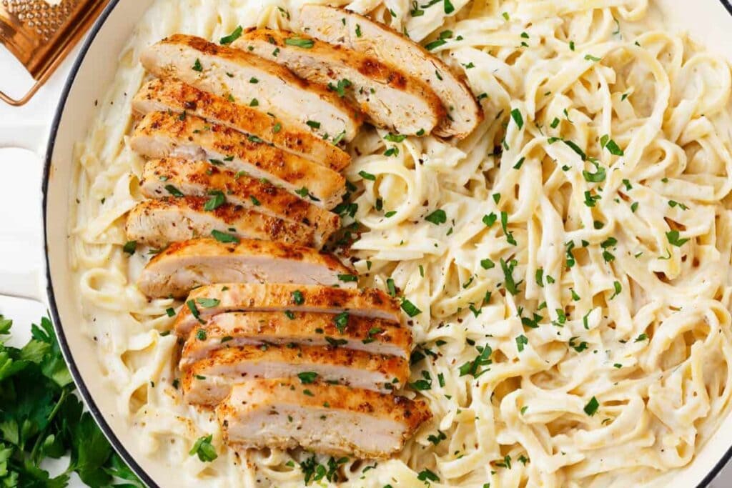 Chicken fettuccine alfredo served on a plate.