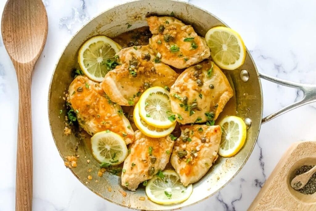 Chicken piccata in a skillet.