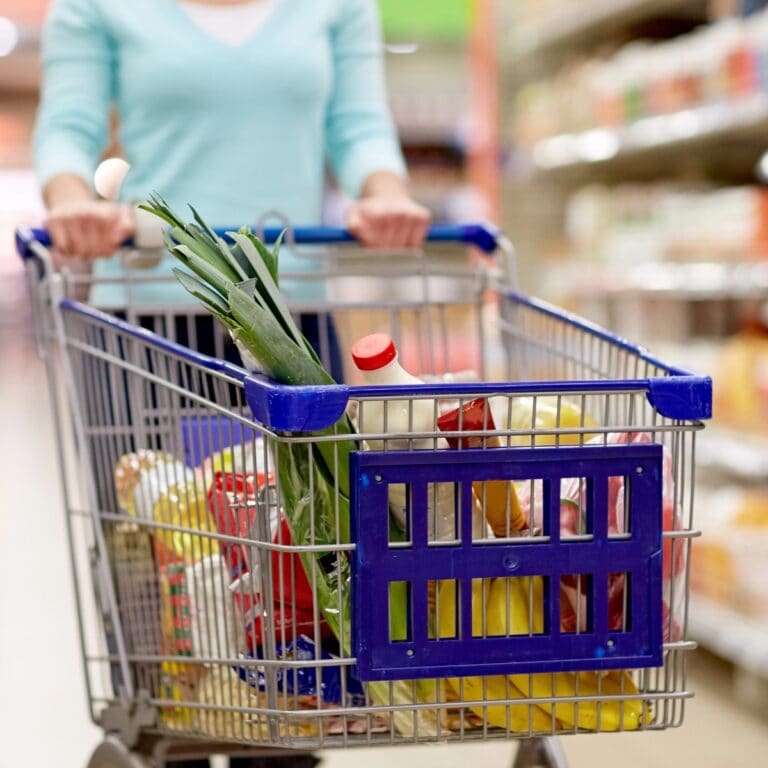 Shopper with a cart of groceries.