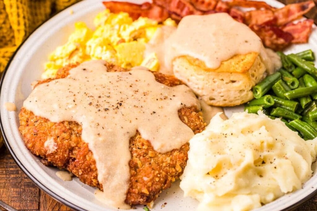Country fried steak served on a white plate.