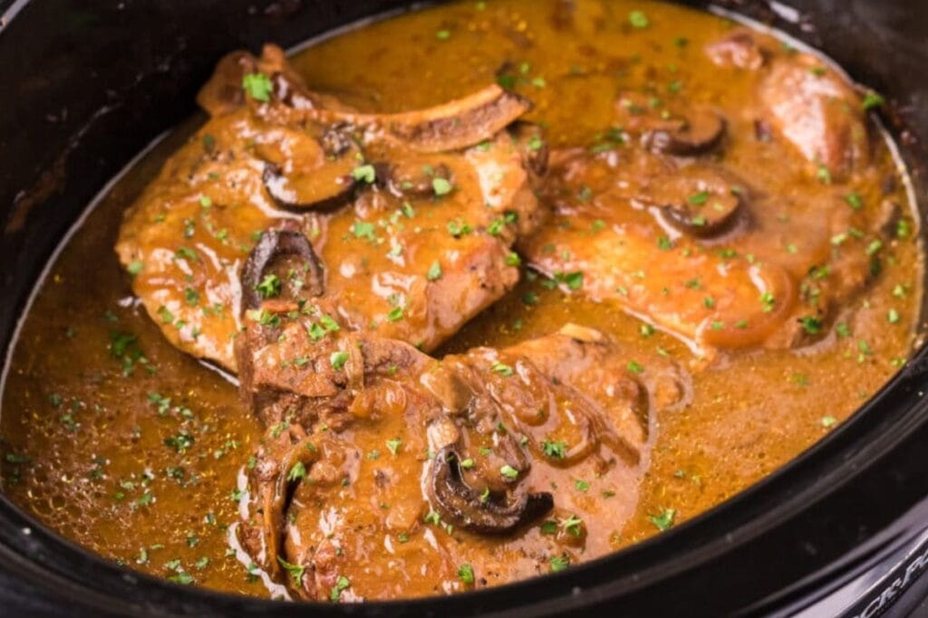 Slow-cooked pork chops with rich gravy.