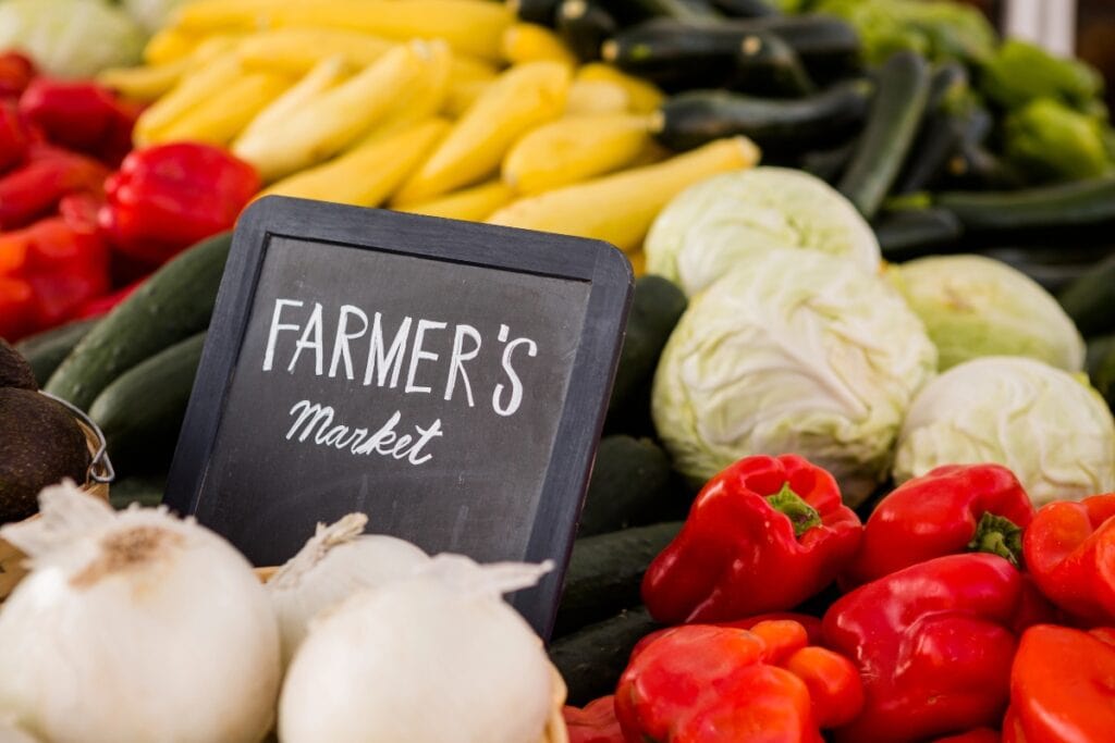 Fresh vegetables displayed at a farmers market stall.