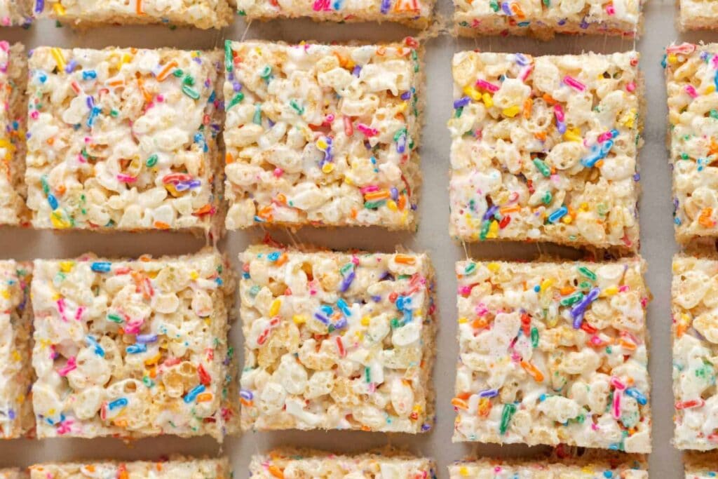 Funfetti Rice Krispie treat bars on parchment paper.