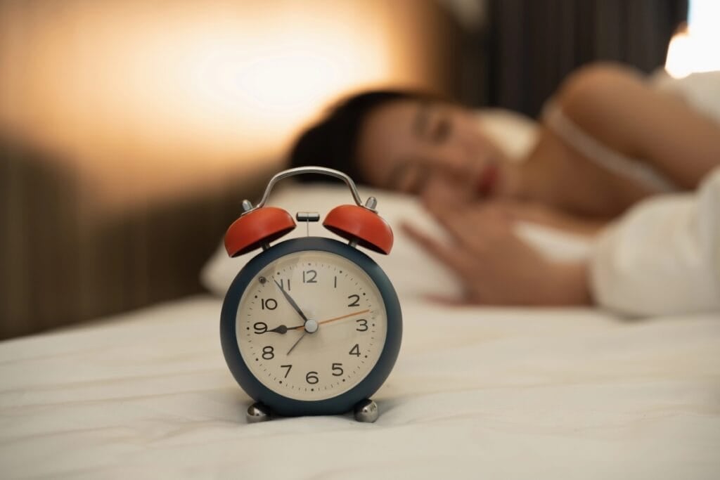 Woman sleeping in bed early at 9 PM.
