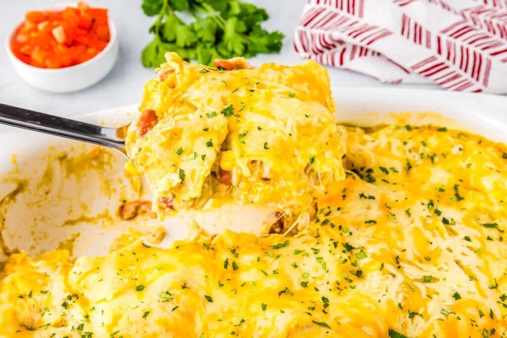 Green chile enchilada casserole in a baking dish.