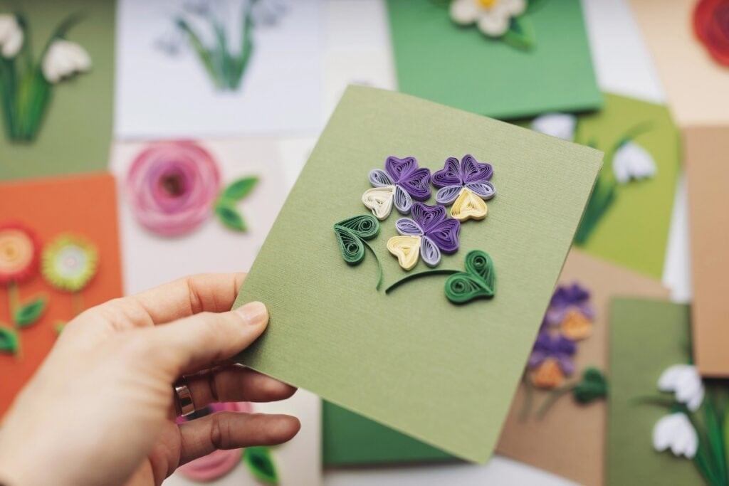 Woman holding greeting card in her hand.
