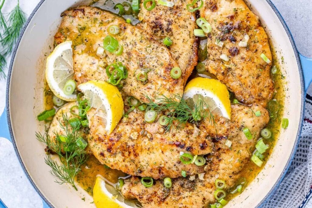 Lemon chicken breast in a skillet.