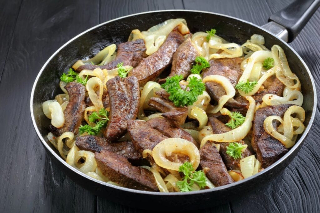 Liver and onions in a skillet.