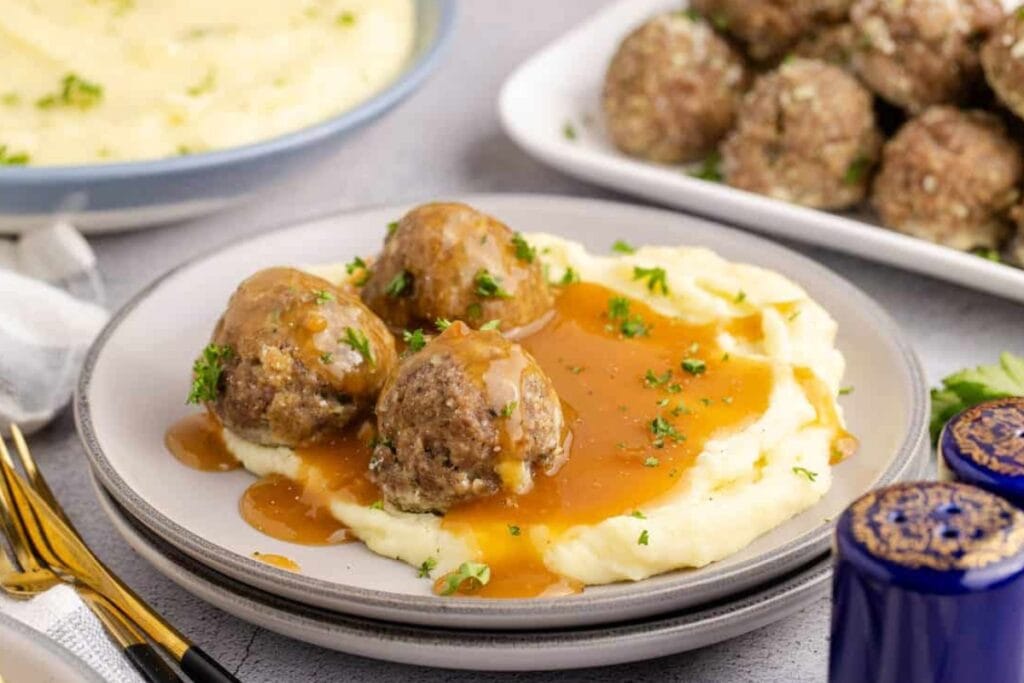 Meatballs served with mashed potatoes on a plate.