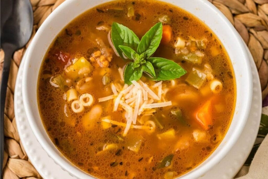 Minestrone soup in a white bowl.