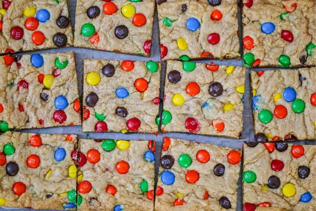 M&M cookie bars on parchment paper.