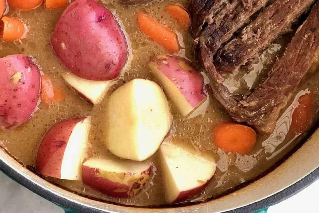 Momma's pot roast with vegetables in a cooking pot.