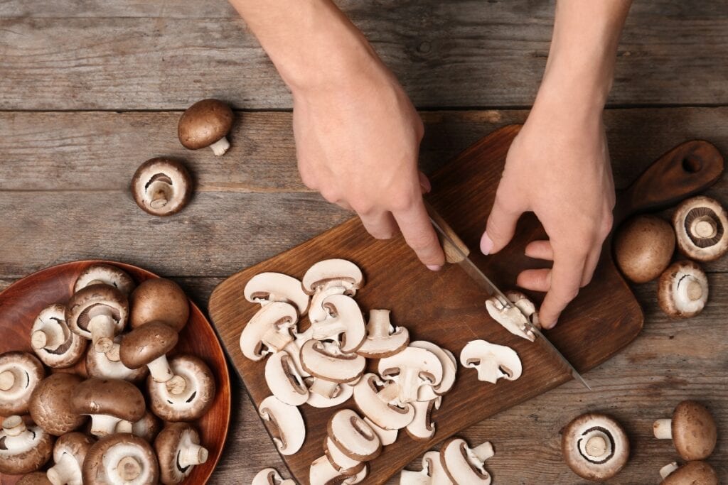 Chopping mushrooms on board.