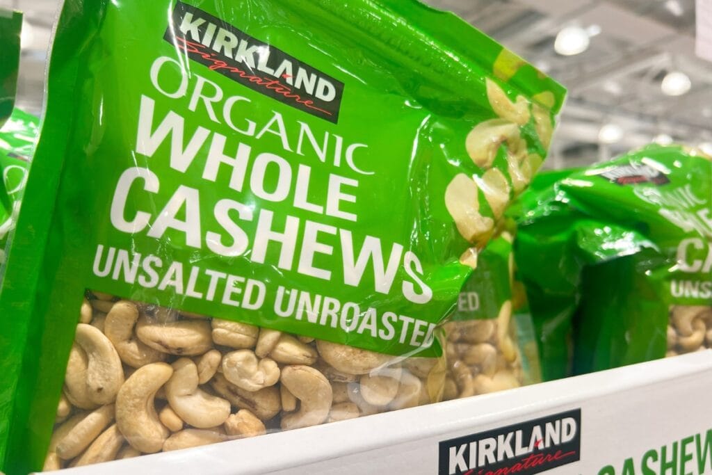 Packs of cashew nuts displayed on store shelves.