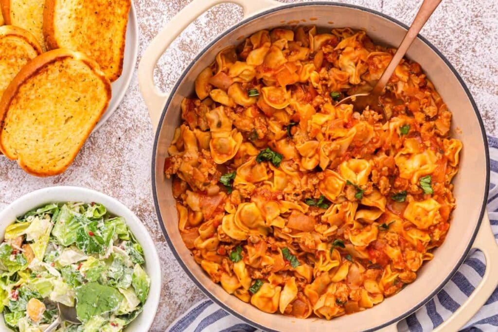 One pot sausage cheese cappelletti pasta in a skillet.