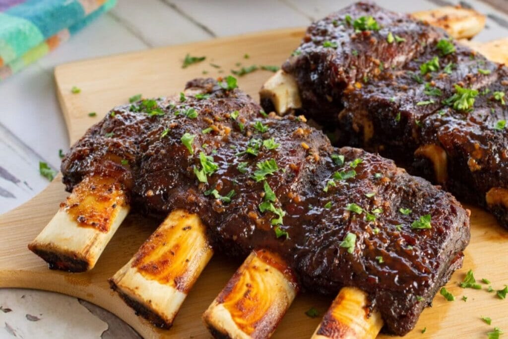 Oven beef ribs on a wooden board.
