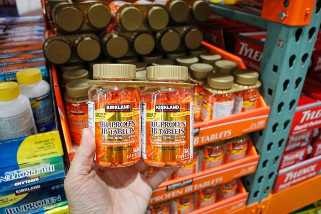 Person holding bottles of over-the-counter medications.