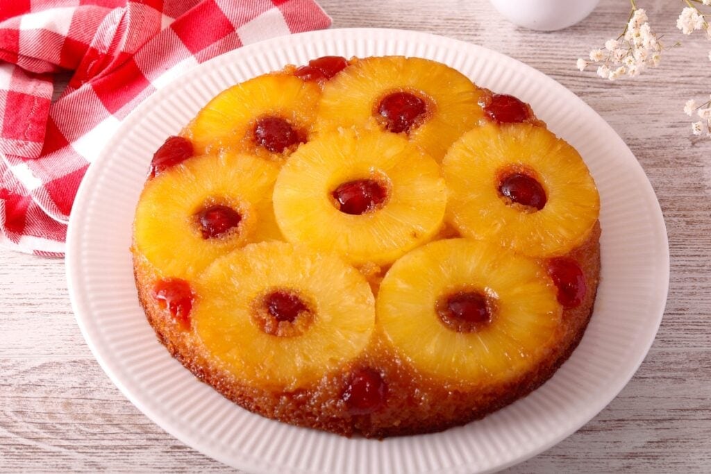 Whole pineapple upside-down cake on a plate.