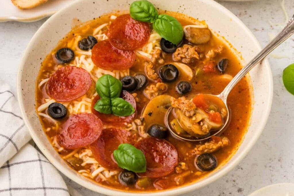 Close-up of pizza soup in a bowl.