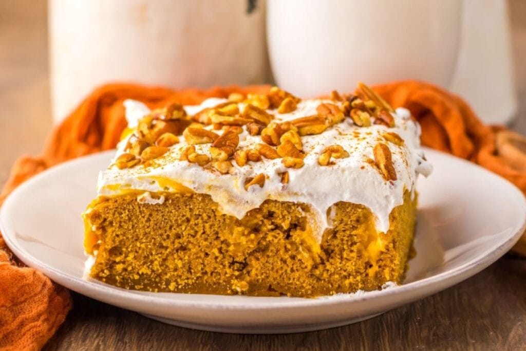Pumpkin gingerbread poke cake on a plate.