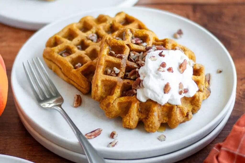 Pumpkin pecan waffles on a plate.