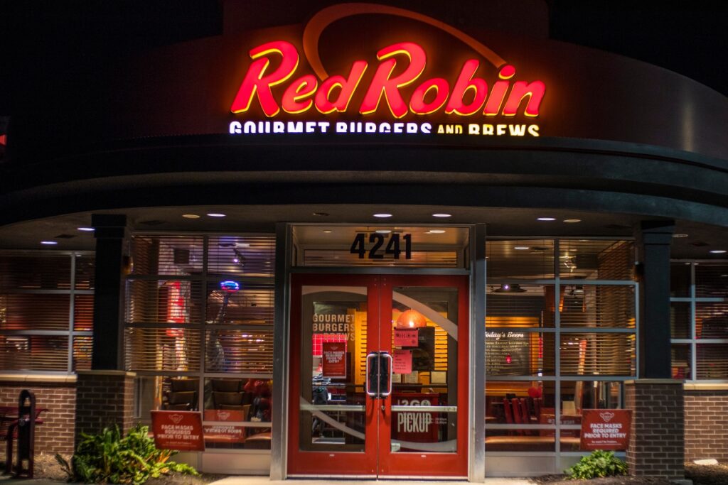 Red Robin restaurant entrance at night with lit sign.