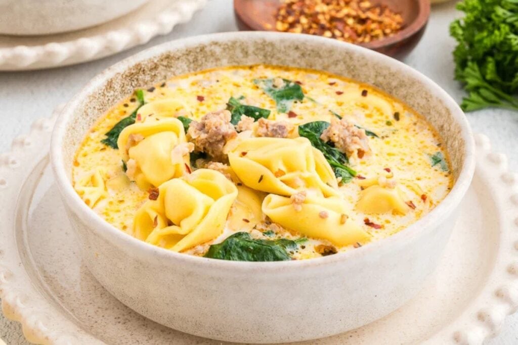 Sausage tortellini soup served in a bowl.