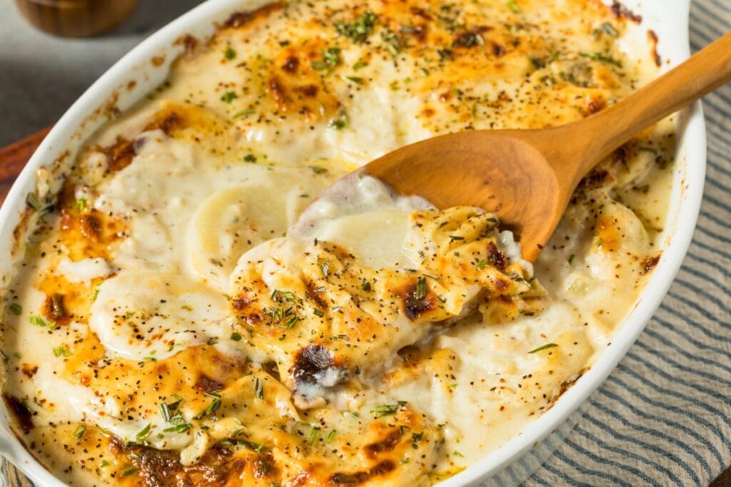 Scalloped and au gratin potatoes in a baking dish.