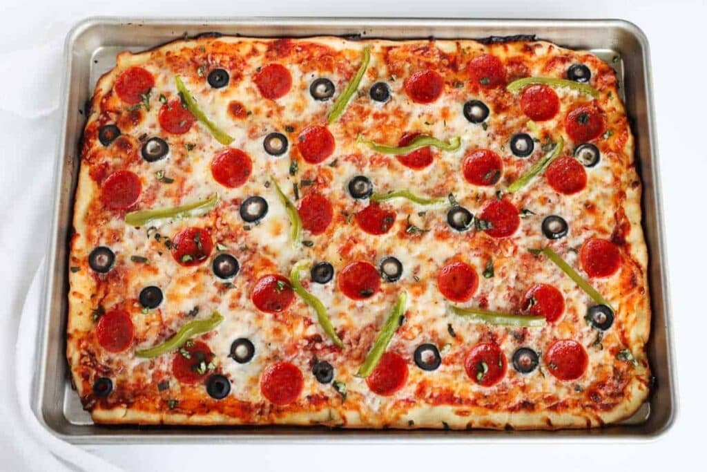 Pepperoni pizza in a sheet pan.