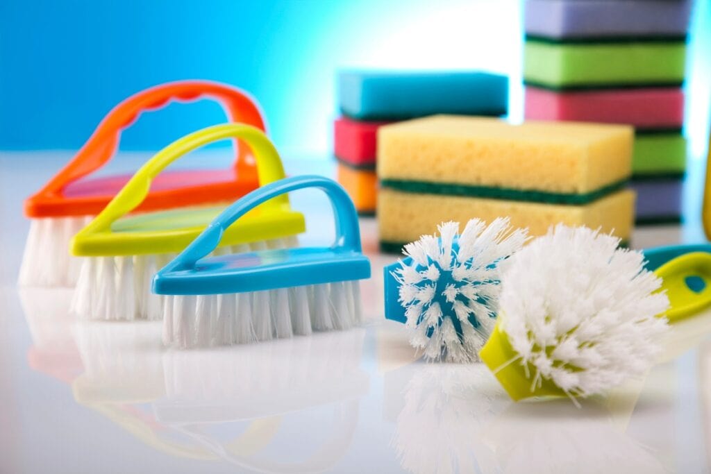 Assorted sponges and scrub brushes for cleaning.