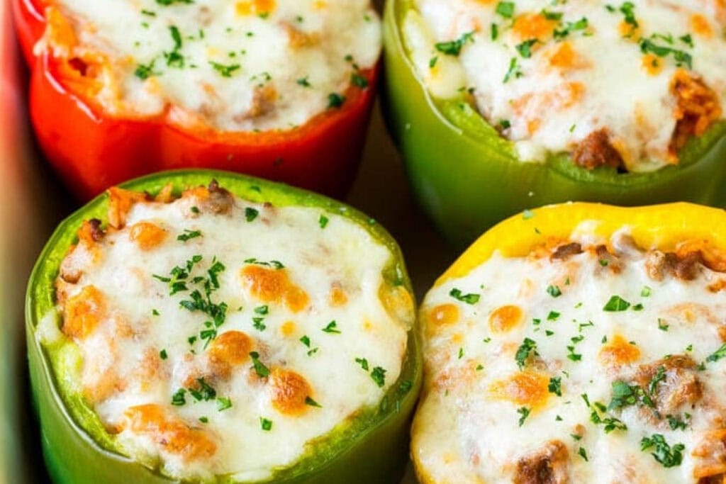 Close-up of stuffed bell peppers in a baking dish.