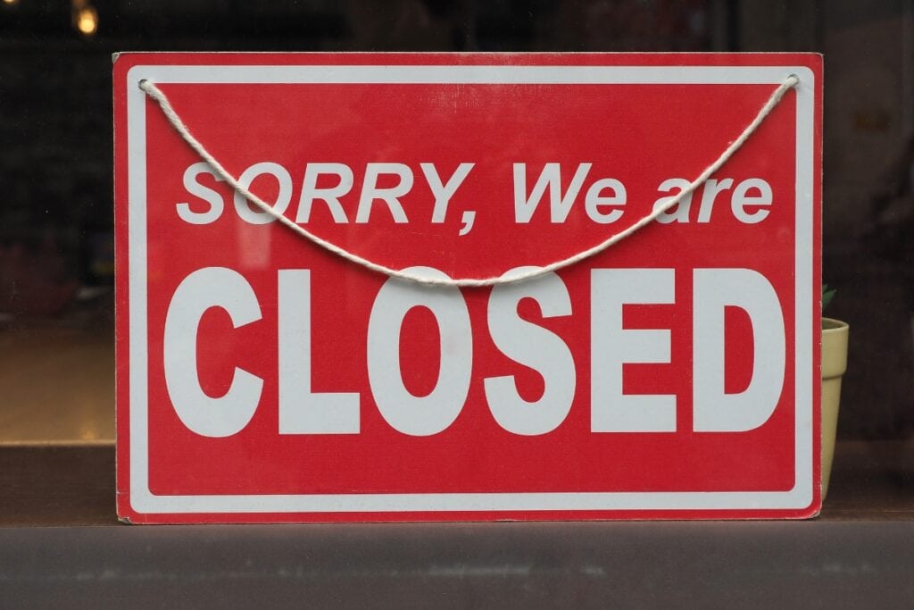 Closed sign on a pharmacy door.