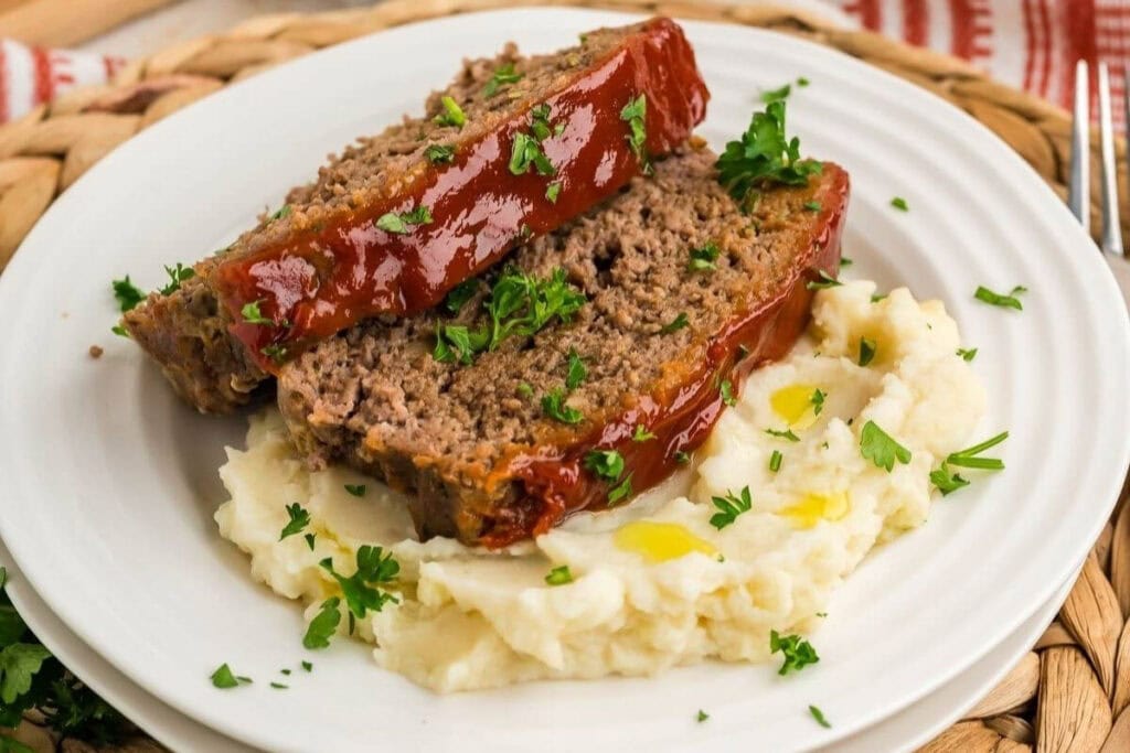 Traditional meatloaf on a white plate.