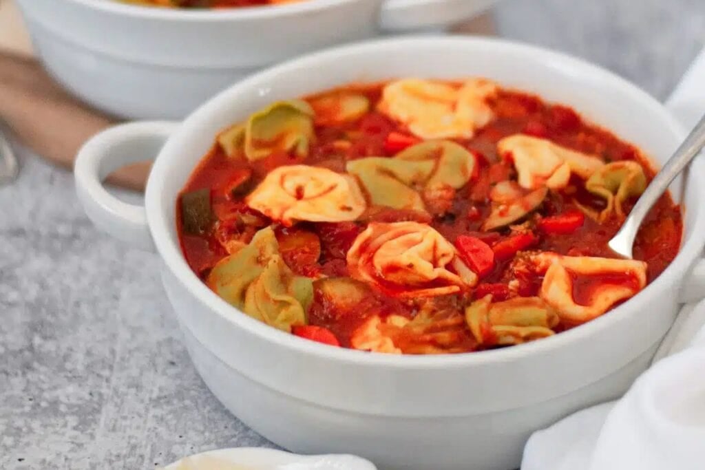 Bowl of vegetarian tortellini soup.