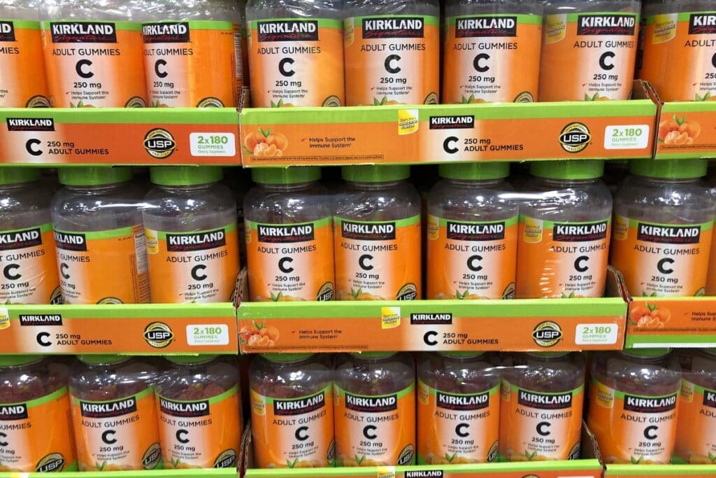 Bottles of vitamins displayed on shelves in Costco store.