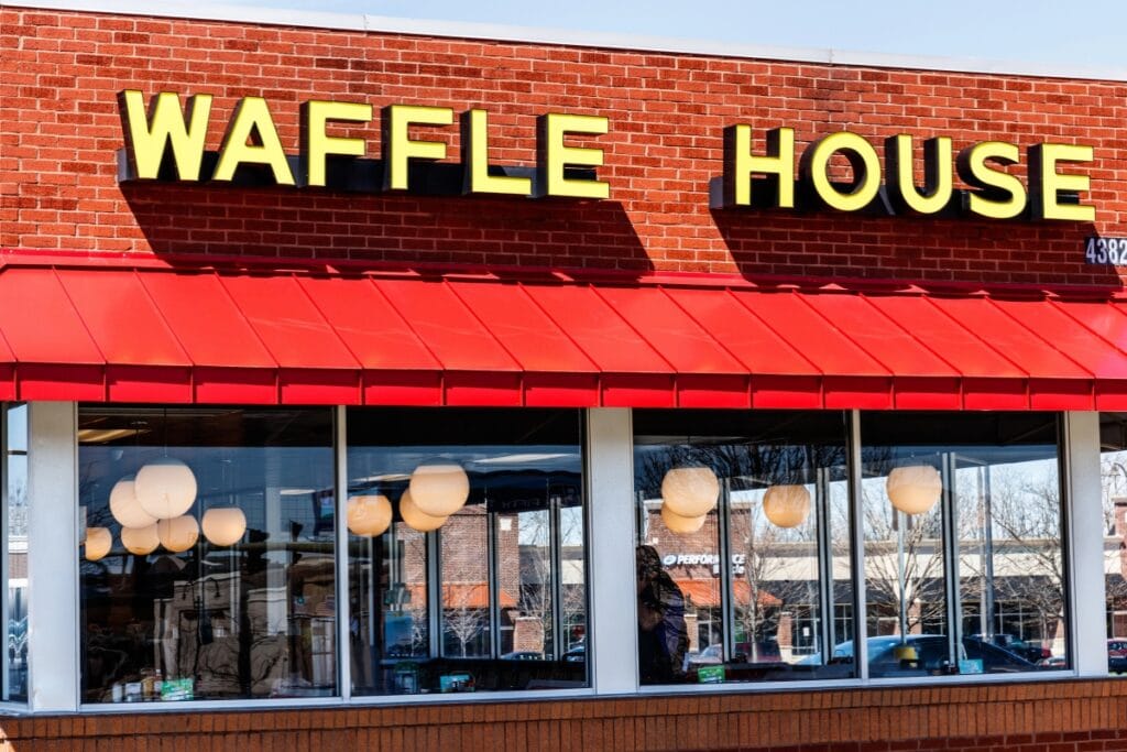 Waffle House front with yellow-black logo and glass windows.