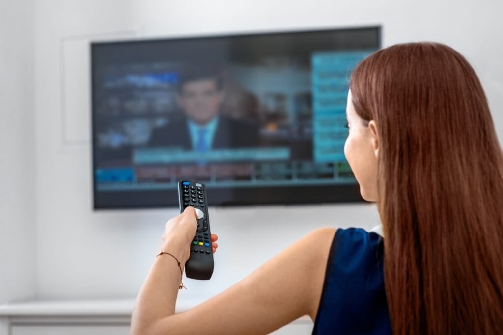 Girl watching the news on TV.