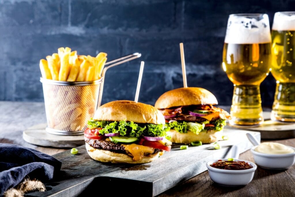 Burger, fries, and a beer on a table at a restaurant.