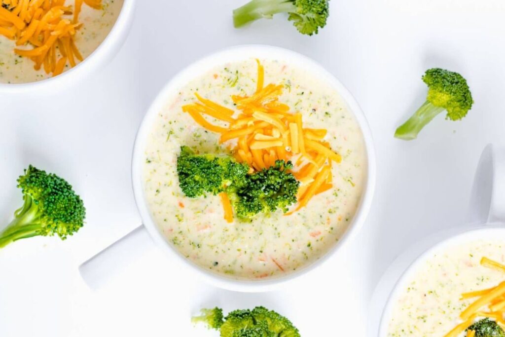 Overhead view of broccoli cheddar soup with broccoli florets.
