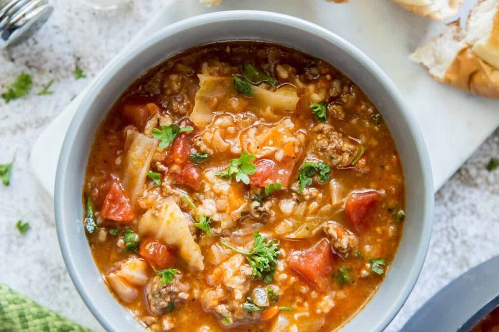 Overhead shot of cabbage roll soup with beef and tomatoes in a bowl.