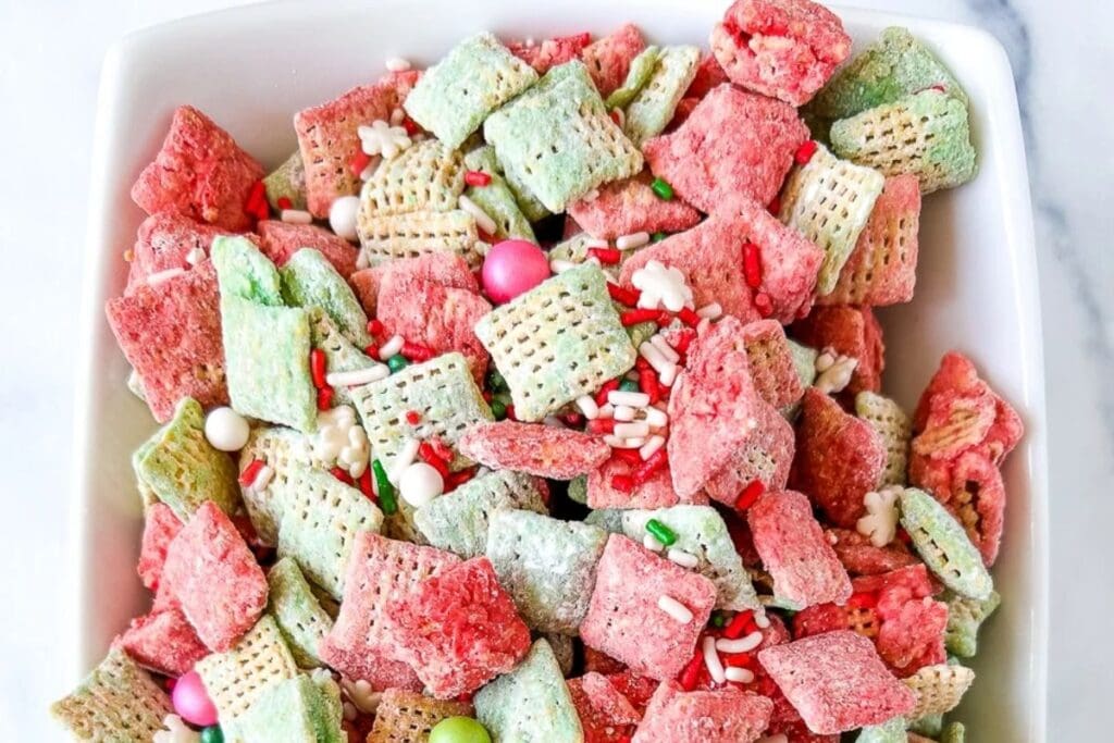 Close-up of Christmas puppy chow in a white bowl.