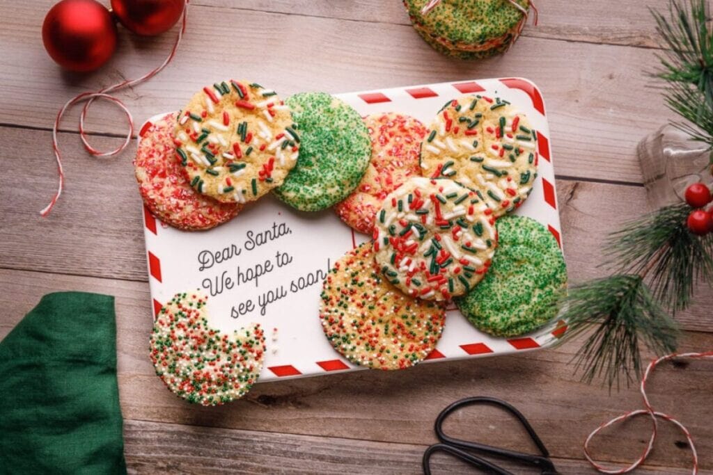 Cookies with sprinkles on a plate that says "Dear Santa, We hope to see you soon!"