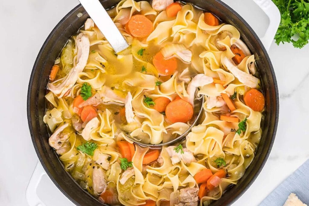 A close up shot of chicken noodle soup.