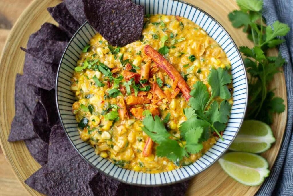 Corn dip with cilantro and lime served with blue corn tortilla chips.