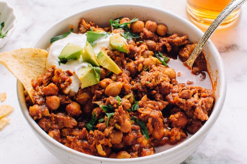 Ground turkey chili with chickpeas, avocado, sour cream, and tortilla chips.